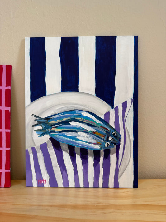 Sardines on purple napkin