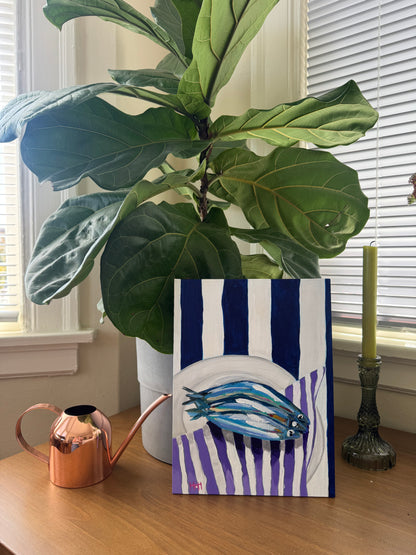 Sardines on purple napkin